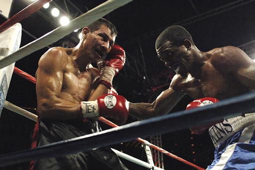 two men participating in a boxing match 