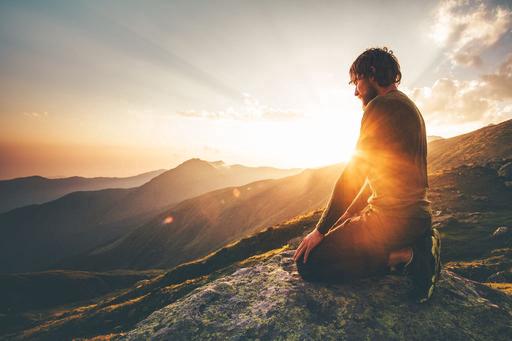 man sitting with sunset in the background