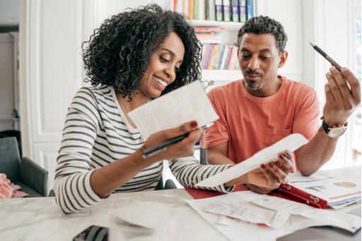 man and woman looking at finances