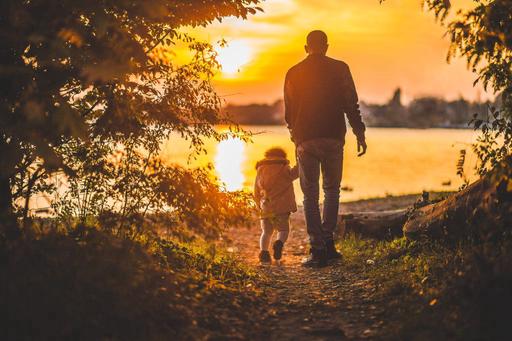 man and child at sunset