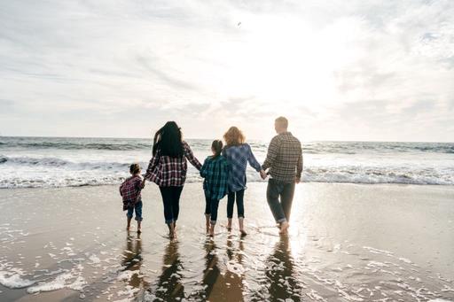 family on a beach at sunset