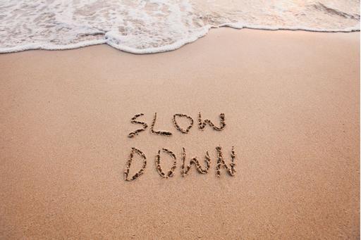 words in the sand saying slow down