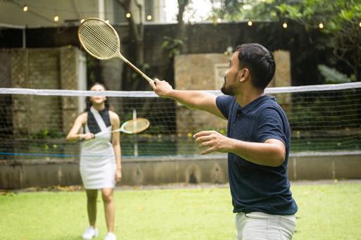 man and woman playing tennis