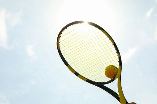 tennis racquet held up to sky