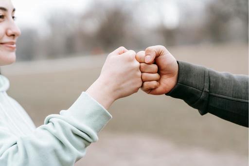 man and woman fist pumping