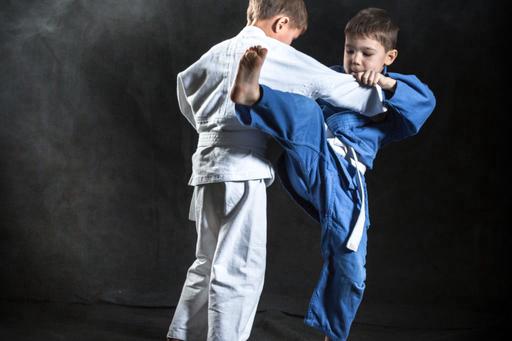 Two children engaging in combat sport 